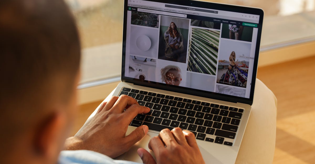 Graphic designer building portfolio on laptop